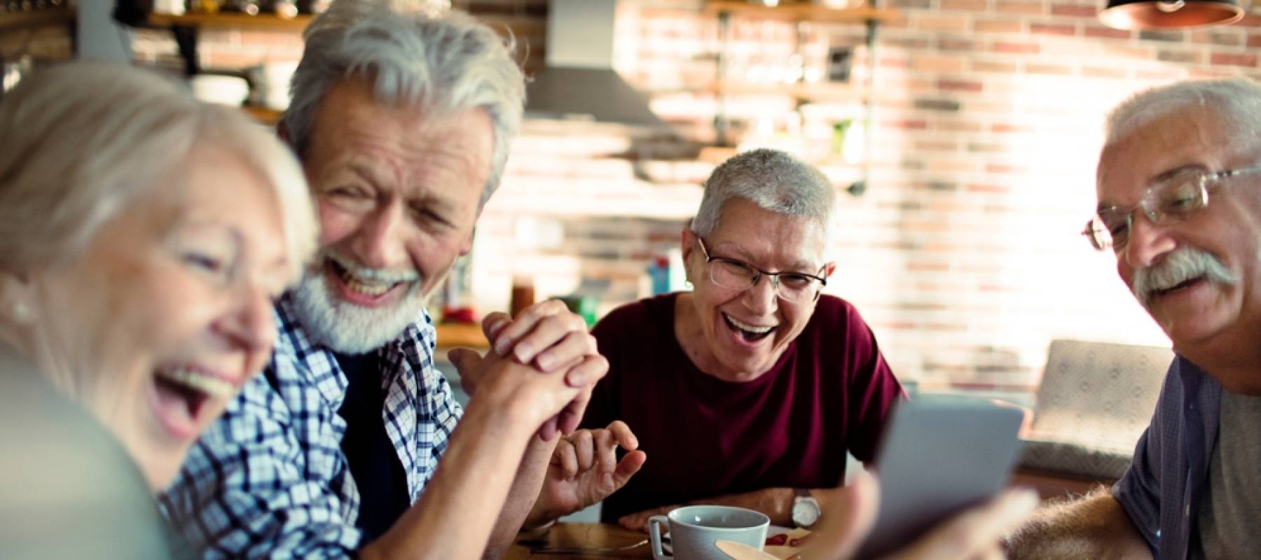 senior friends enjoying conversation and breakfast together