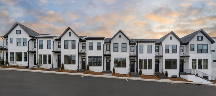 Image of exterior of semi-detached homes on a sunny day.