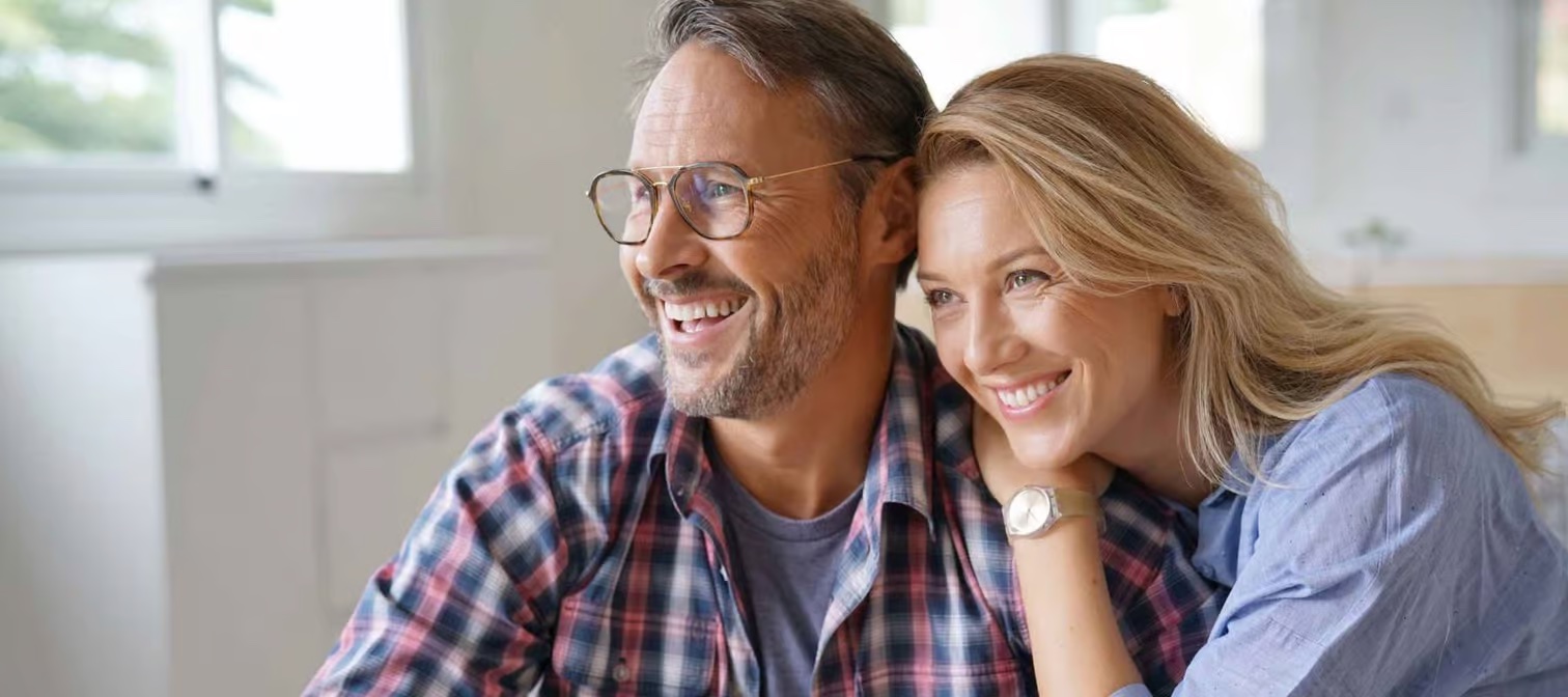 Happy couple thinking about retirement at 50