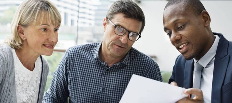 Older couple speaking with a retirement advisor