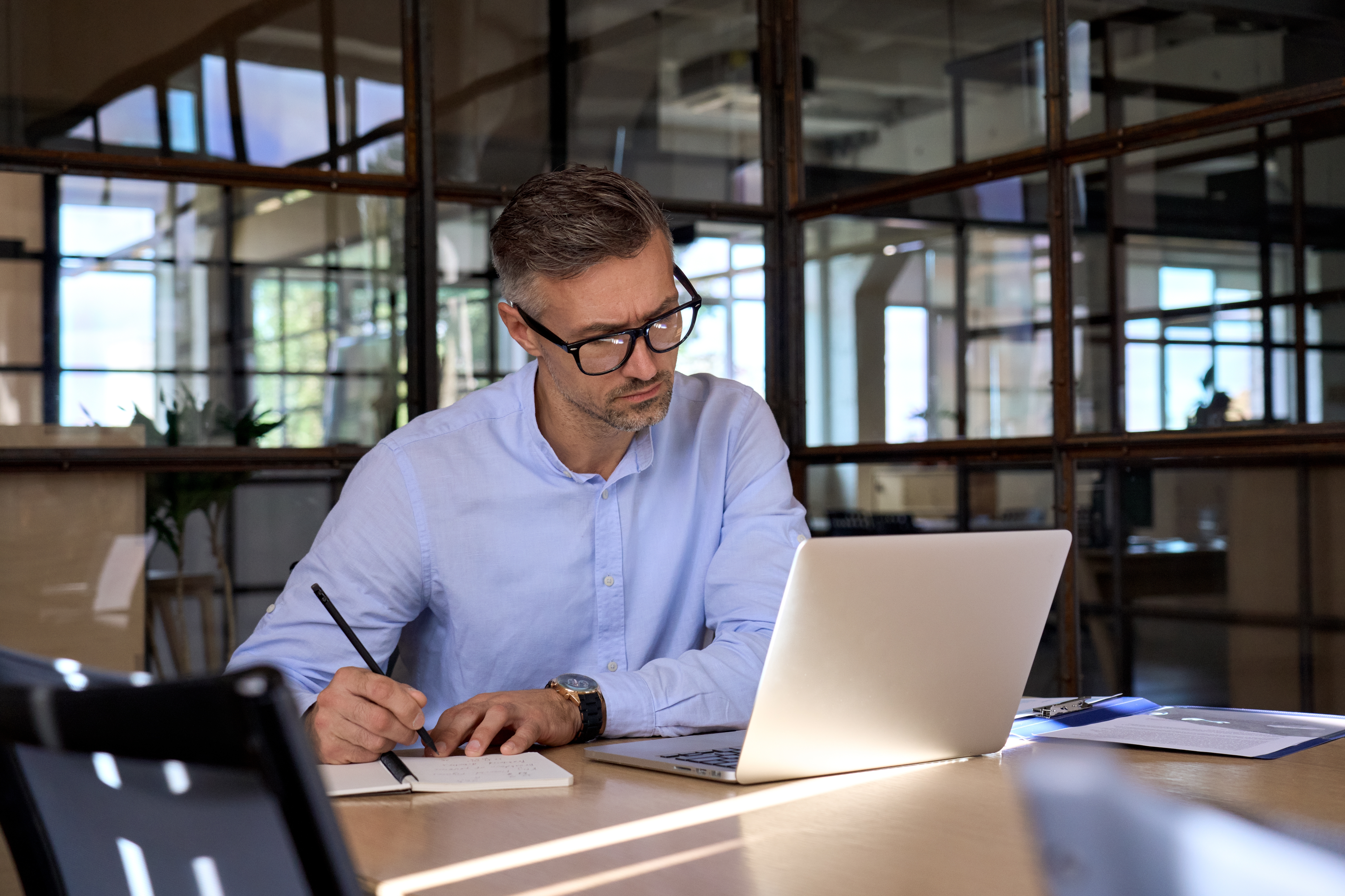 Mature business man executive manager looking at laptop computer watching online webinar training