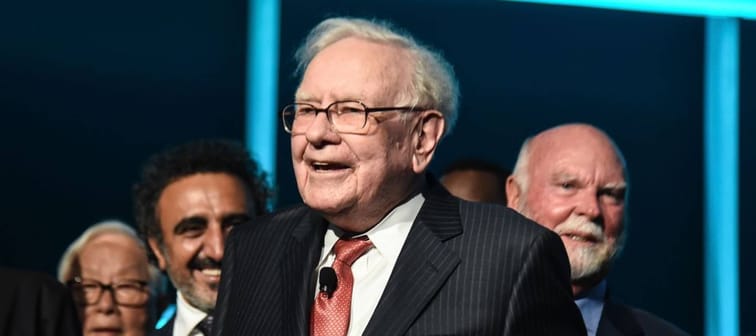 Warren Buffett (C) is joined onstage by 24 other philanthropist and influential business people featured on the Forbes list of 100 Greatest Business Minds