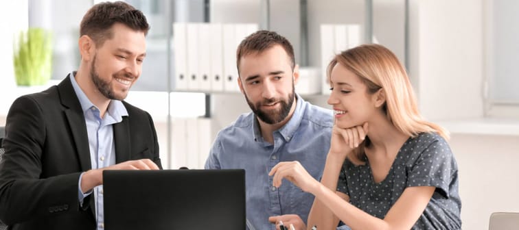 young couple at a bank speaking with advisor