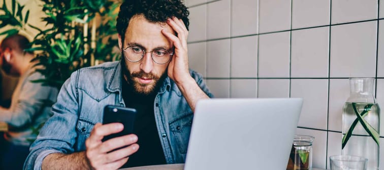 Worried bearded young man reading searching for information about his amended tax return